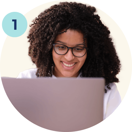 women looking at laptop and smiling